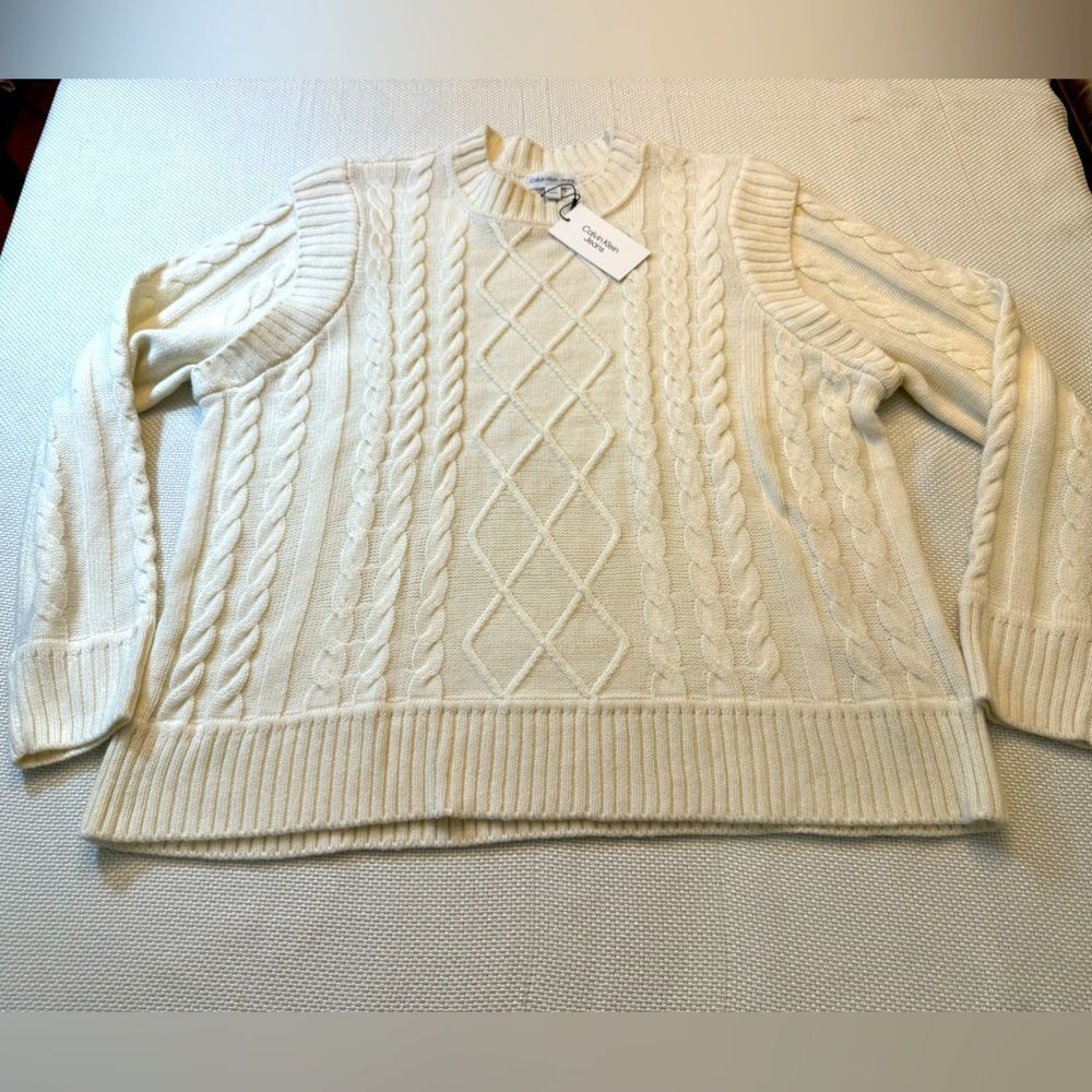 NWT Calvin Klein cable knit sweater with unique sleeves. Size XL ivory cream
